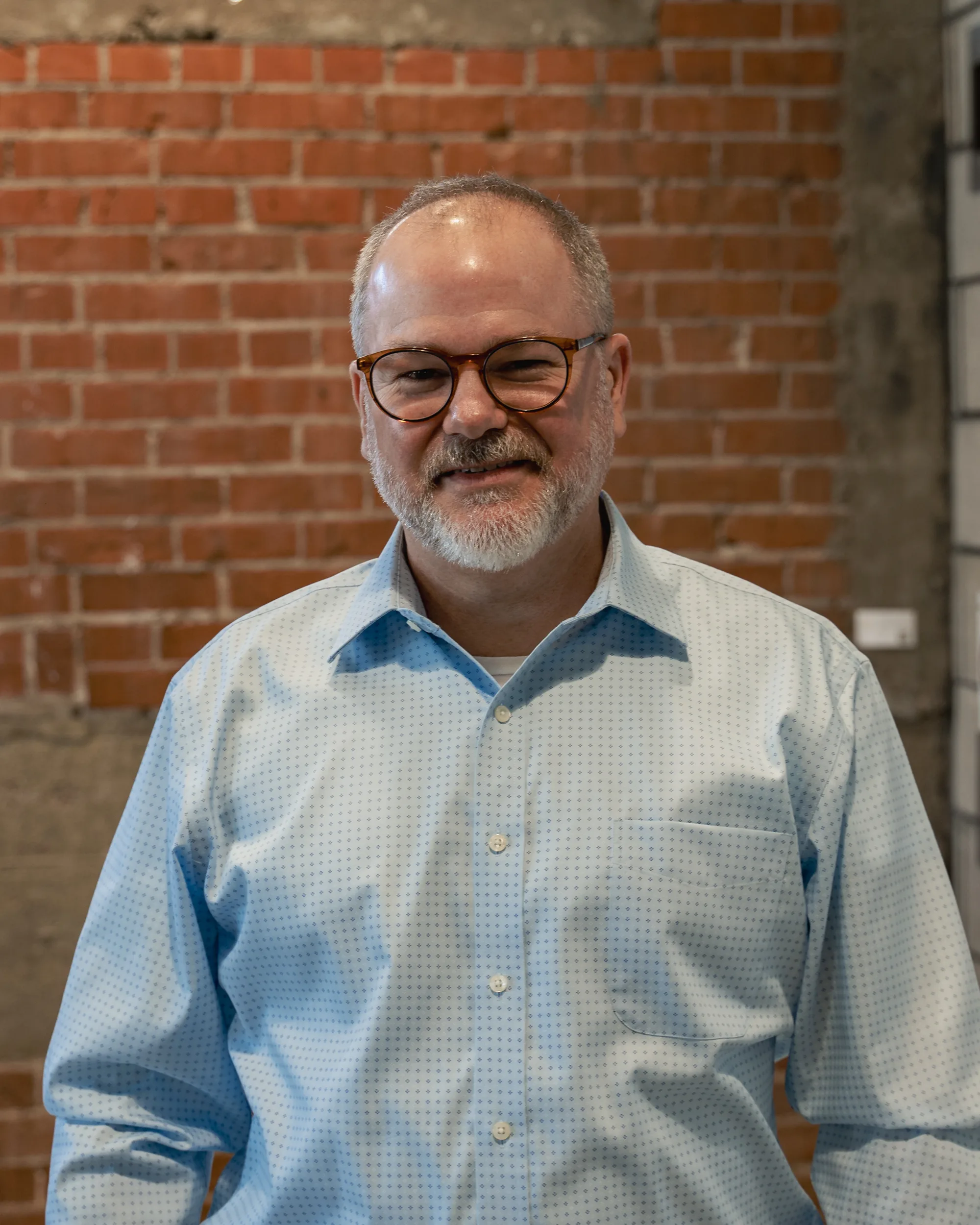 A leadership conversation in a brick-walled workspace
