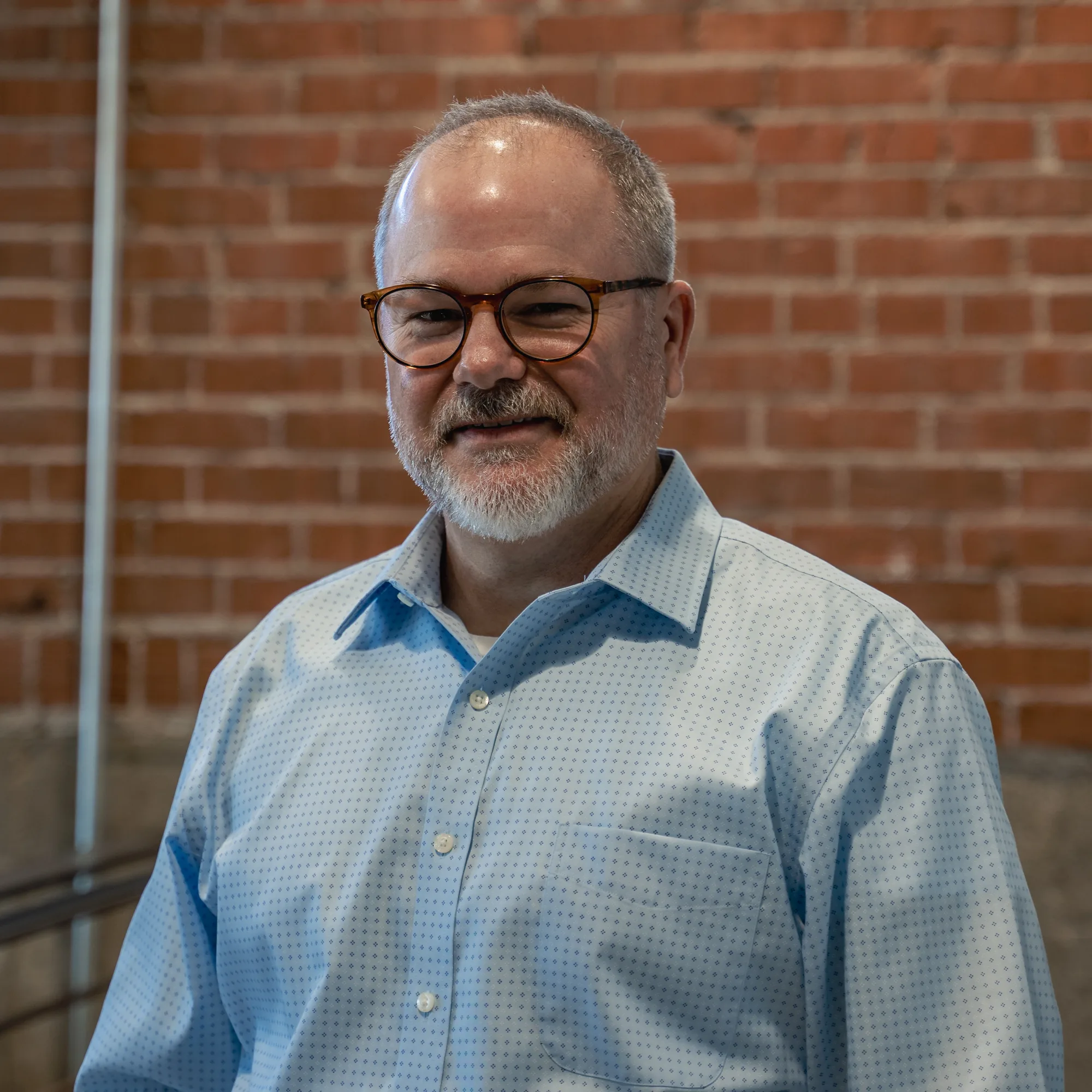 A StrongerWork founder, smiling, in the Tempe office